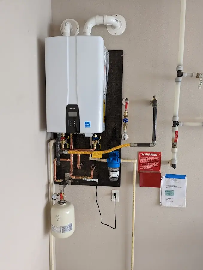 Professional plumber installing copper piping in a Huntingtown home